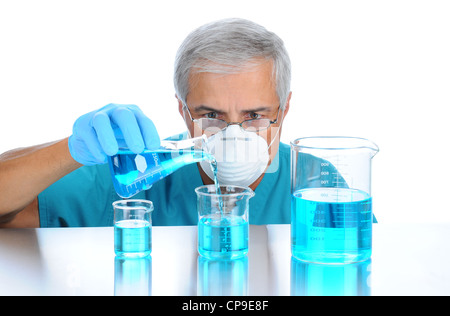 Scientist pouring measuring liquids in assorted beakers. Horizontal format over white background. Stock Photo