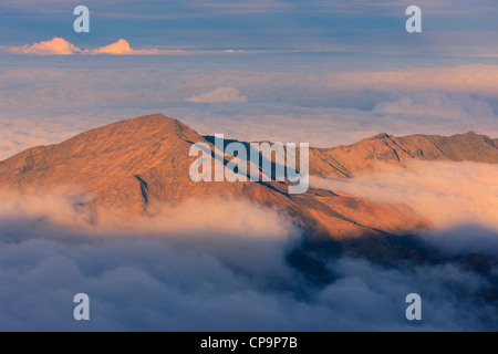 Sunset above the clouds over 3000 meters at the Haleakala Volcano, Maui, Hawaii