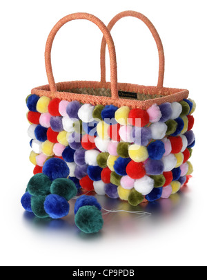 multi colored wool bobble covered straw hand bag Stock Photo