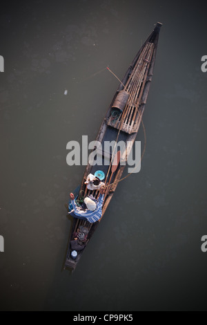 Looking down from above on a dhoni a traditional style of boat a man fishing Bago Burma Myanmar Burma Stock Photo