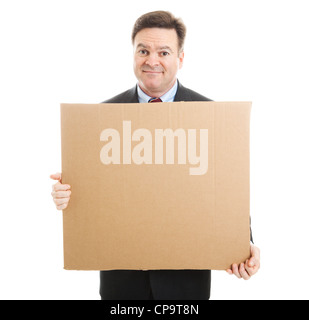 Embarrassed jobless businessman holding up a blank cardboard sign. Isolated on white. Stock Photo