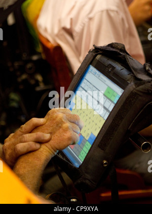 physically disabled man uses touch-screen computer attached to his ...