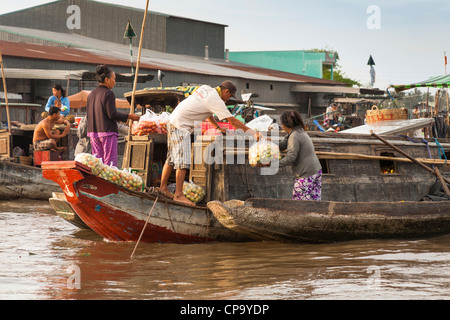 People selling tomatoes from a boat in the floating market, Cai Rang near Can Tho, Mekong River Delta, Vietnam Stock Photo