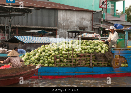 Man selling vegetables from a boat in the floating market, Cai Rang near Can Tho, Mekong River Delta, Vietnam Stock Photo