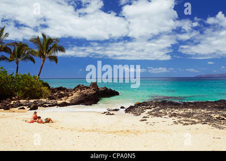 Couple on vacation enjoy Secret Beach, Maui, Hawaii. Stock Photo