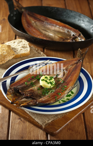 Kippers smoked herrings on plate Stock Photo
