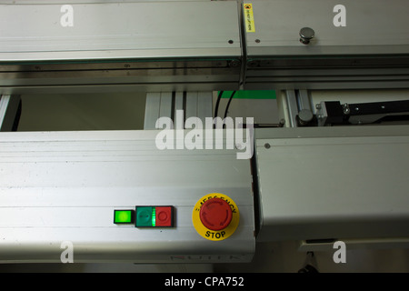 stop, go and emergency stop button used on conveyor belt section within smt smd assembly production line. Stock Photo