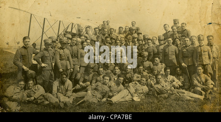 World War I-era photograph of Italian army soldiers in front of an old biplane. Stock Photo