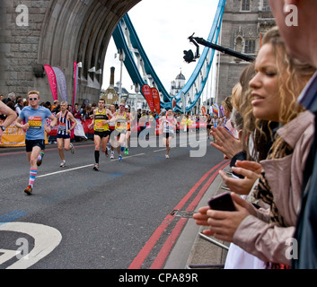 Spectators applauding London 2012 marathon athletes competitors runners on Tower Bridge London England Europe Stock Photo