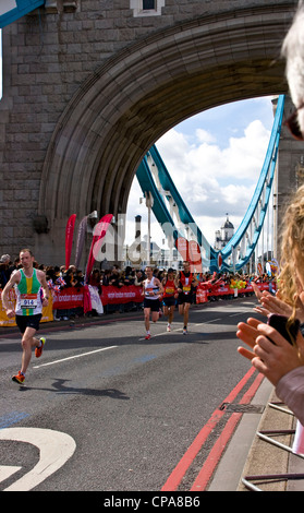 2012 London marathon runners crossing grade 1 listed Tower Bridge London England Europe Stock Photo