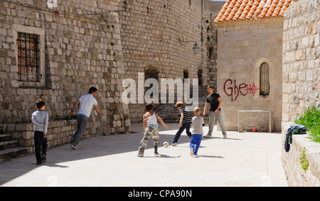 Dubrovnik, Croatia - fathers and sons playing football in the old town. Stock Photo