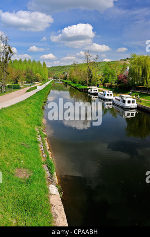 Three barges moored on the Yonne River, Canal du Nivernais Burgundy, France. Stock Photo