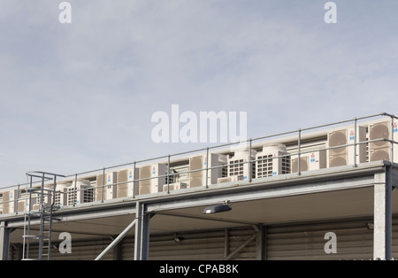 A row of Mitsubishi air conditioning units on an exterior  mezzanine floor level of an industrial building. Stock Photo