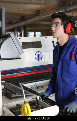 Factory worker operating machine Stock Photo