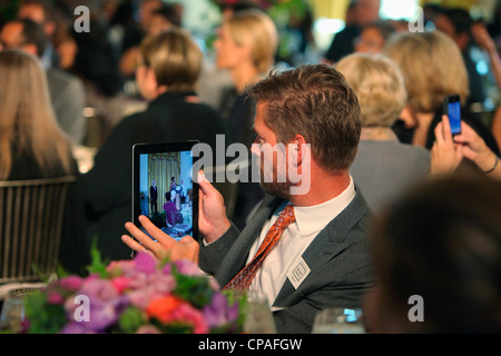 An award winner uses an iPad to record the First Lady Michelle Obama for the Winners of the 2011 National Design Awards Stock Photo