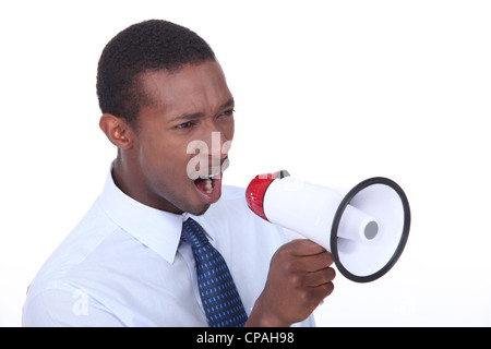 African man shouting through a megaphone Stock Photo