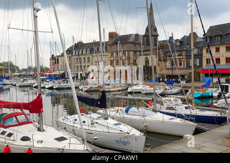 The historic fishing village of Honfleur, Normandy. Pleasure yachts tie up in the basin and restaurants line the wharf. Stock Photo