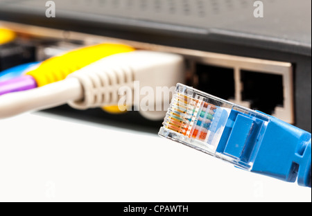 Single blue cat5 cat5e cable loose from internet router or technology switch Stock Photo