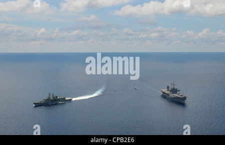 The Royal Australian Navy frigate HMAS Ballarat (FF 155), left, breaks away from the U.S. 7th Fleet flagship USS Blue Ridge (LCC 19) while transiting the South China Sea. Stock Photo