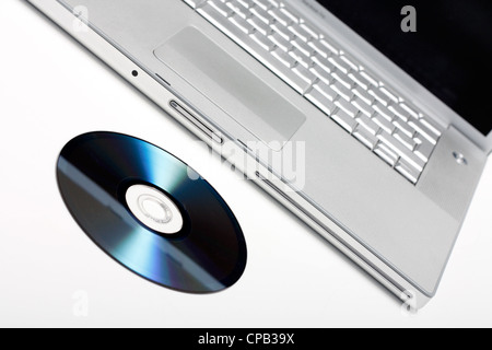 Laptop and CD isolated on white Stock Photo