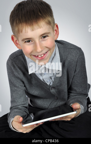 Portrait of a cheerful boy with tablet computer Stock Photo