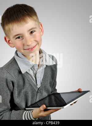 Portrait of a cheerful boy using a tablet computer. Clipping path included Stock Photo