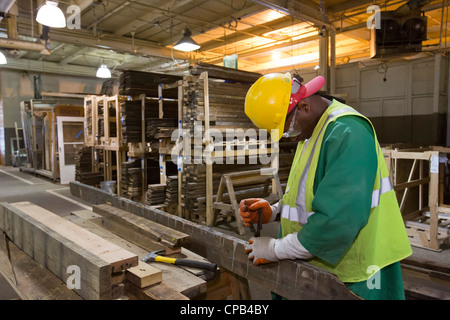 Workers Recycle Building Materials Salvaged from Deconstruction of a House Stock Photo