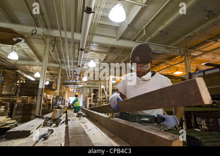 Workers Recycle Building Materials Salvaged from Deconstruction of a House Stock Photo