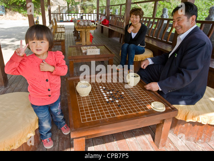 A local Chinese family pose for the camera at a rest area on Mount Kongtong near Pingliang city in China. Stock Photo