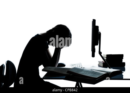 one caucasian young teenager silhouette boy or girl studying with computer computing laptop tired sad despair in studio cut out isolated on white background Stock Photo