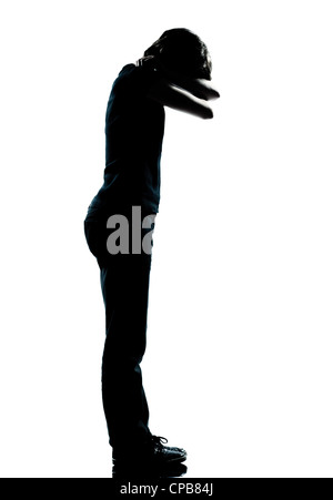 one caucasian young teenager silhouette boy or girl crying full length in studio cut out isolated on white background Stock Photo