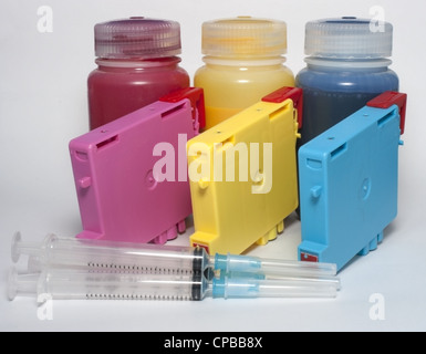 Ink cartridges and bottles of refill and syringes Stock Photo