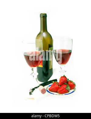 opened red wine bottle and two glasses and fresh strawberries isolated on white Stock Photo