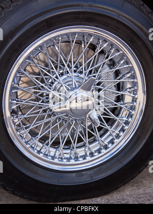 Polished chrome spokes on a vintage car tyre Stock Photo