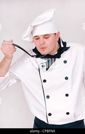 chef with large spoon on the gray background Stock Photo