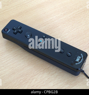 Close Up of a Nintendo Wii Black Remote Controller on a Wooden Surface Stock Photo