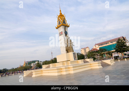 Horizontal wide angle of the Cambodia-Vietnam Friendship Monument in Phnom Penh with a guard on the plinth to show it's scale Stock Photo