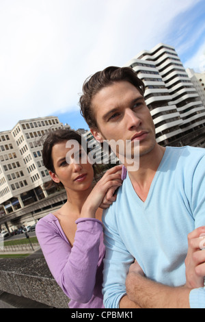 Couple in front of tall buildings area Stock Photo