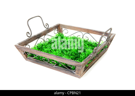 Empty wooden tray with grass over white background Stock Photo