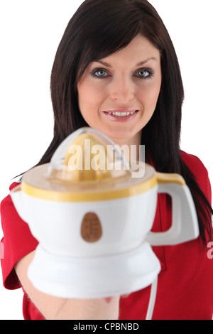 Woman holding an electric lemon squeezer Stock Photo