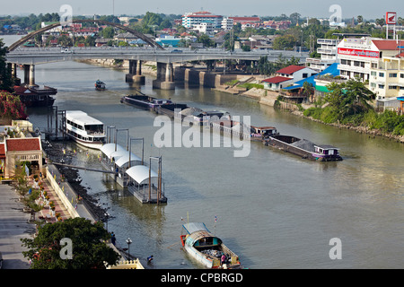 Coal transporter shipping moving down the Chao Phraya river leaving Ayutthaya to Bangkok. Thailand Stock Photo