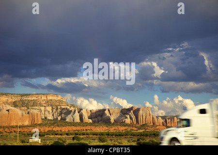 White truck passing rock formation and strom cloulds USA Stock Photo