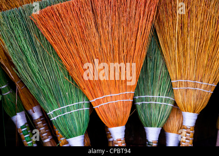 Coloured handmade brooms Stock Photo