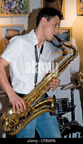 Young musician playing jazz saxaphone at Cine Mourguet St Foy les Lyon France during Caravane des Cinemas d'Afrique March 2012 Stock Photo