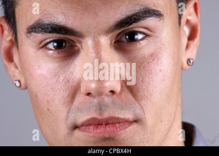 Close up of a white man's face on grey background (not retouched) Stock Photo