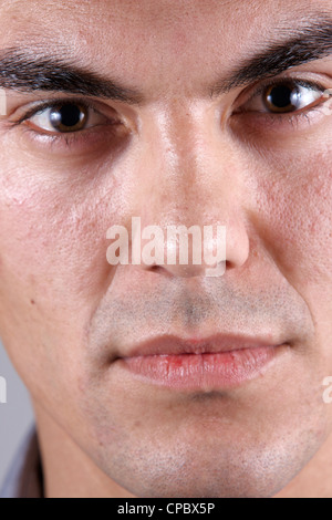 Close up of a white man's face on grey background (not retouched) Stock Photo