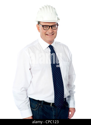 Handsome smiling aged engineer with hard hat on his head isolated on white Stock Photo