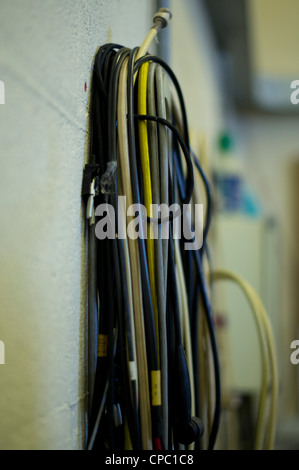 Bundle of color cables on a wall hanging Stock Photo