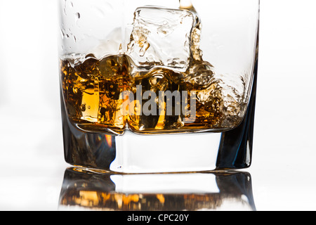 Whiskey on the rocks being poured Stock Photo