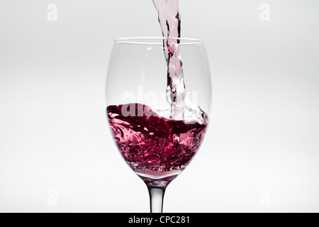 Pink wine pouring Stock Photo